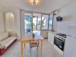 a kitchen and living room with a table and a couch at Residence Maresol in Vieste