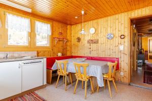 a kitchen with a table and chairs in a room at Sunny Mountain in Reckingen - Gluringen
