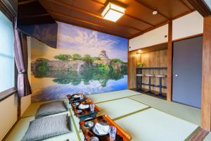 a room with a painting on the wall at SAMURAI Base in Hakone +44 photos