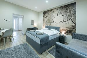 a bedroom with a large bed and a dining room at Polár in Makó