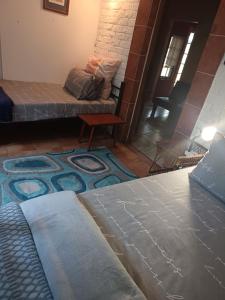 a living room with a couch and a rug at Apartment-double storey-2 bedrooms-own bathroom, kitchen, dining room, entrance, lounge, patio in Pinetown