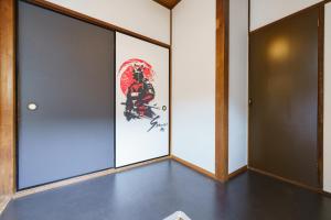 a room with doors and a painting on the wall at SAMURAI Base in Hakone