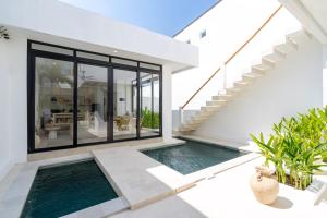 an external view of a house with a swimming pool at Casa Agapi in Tumbak Bayuh