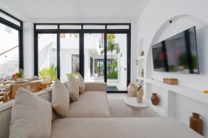 a living room with a couch and a large window at Casa Agapi in Tumbak Bayuh +77 photos