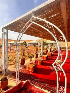 a group of red carpeted stairs with a tent at Luna Camp Merzouga in Merzouga +170 photos