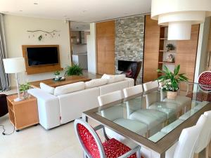 a living room with a white couch and a glass table at Villa de Lujo en Campo de Golf - Costa Brava in Peralada