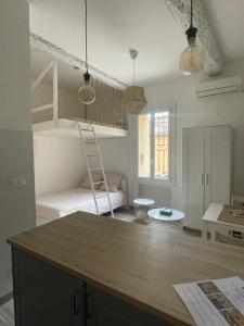 Una habitación con una litera con una escalera dentro. en Studio vieil Antibes et mezzanine proche de la mer, en Antibes