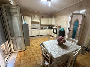 a kitchen with a table with chairs and a refrigerator at B&B MAGEVA in Naples