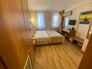 a small bedroom with a bed and a desk at Timeks Hotel Sultanahmet in Istanbul +37 photos