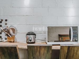 a kitchen counter with a toaster and a toaster oven at Branta Home Homestay Yogyakarta in Timuran