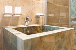 a bathroom with a sink and a shower at Landhaus Butt 05 in Ahrenshoop +22 photos