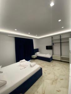 a hotel room with two beds and two bedsvisor at Relax Apartments SB in Himare