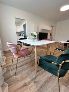 a dining room with a white table and chairs at Apartment NovumSpot Free ParkingSpot in Prešov
