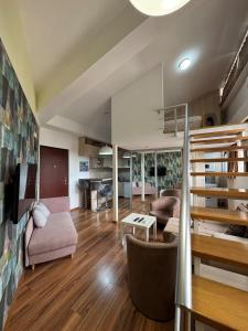 a living room with a loft bed and a couch at Royal Central Apartment in Bar