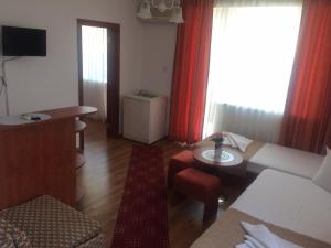 a living room with a couch and a table at Family hotel Dramchev in Nesebar