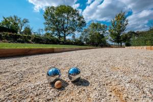 two baseball mitts sitting on top of a gravel road at Gîte du Chapy in Beauraing