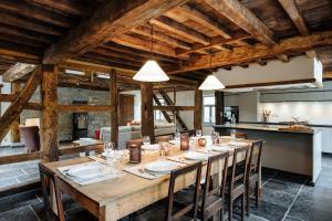 a large dining room with a long table and chairs at Gîte du Chapy in Beauraing