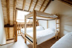 two bunk beds in a room with a window at Gîte du Chapy in Beauraing