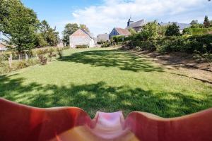 a bench sitting in the grass in a yard at Gîte du Chapy in Beauraing