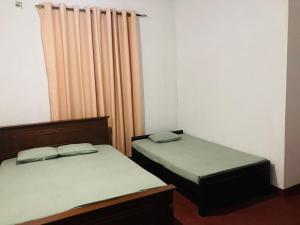 Letto o letti in una camera di Yu Home Stay Anuradhapura