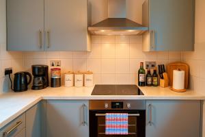 a kitchen with a stove and a counter top at The South Promenade apartment in Newcastle