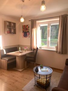 a living room with a table and a window at AH Carinthia Mallnitz - Carinthia Appartements in Mallnitz