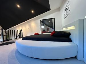 a bedroom with a large white bed in a room at Love Room La Crèche Romantique in Bogny Sur Meuse +51 photos