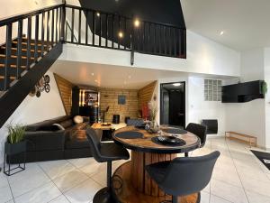 a kitchen and living room with a table and chairs at Love Room La Crèche Romantique in Bogny Sur Meuse