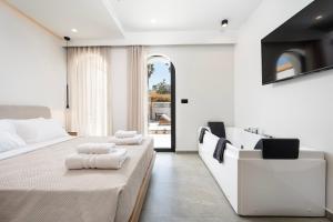 a white bedroom with two beds and a sink at Casarela in Marmari +201 photos
