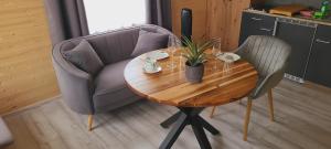 a wooden table with a chair and a table with a plant at Ferienwohnung Sylvia in Neustrelitz +24 photos