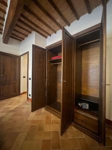 a living room with wooden cabinets and a tv at Casa Arte in San Quirico dʼOrcia +28 photos