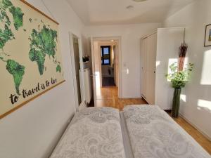 a bedroom with a bed and a map on the wall at FeWo Alte Mainbrücke in Würzburg