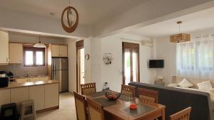 a kitchen and a living room with a couch and a table at Villa Mellia in Bali