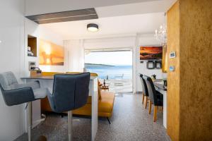 a kitchen and dining room with a view of the ocean at Happy Beach Apartment - Dream on the Beach in Kraljevica