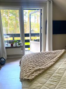 a bedroom with a bed and a large window at Villa Åhus nearby The Beach in Åhus