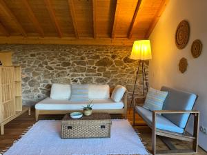 a living room with a couch and a chair at Quinta da Mata de Baixo in Dornes
