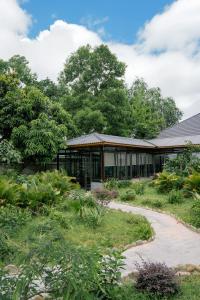 a building with a garden in front of it at Dragon Mountain Home in Ninh Binh - Center Of Heritage in Ninh Binh