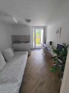 a living room with a couch and a table at appartement cosy entier et parking privé sur place a 5min de lille et 10 min du Stade Pierre Mauroy in Mons-en-Baroeul