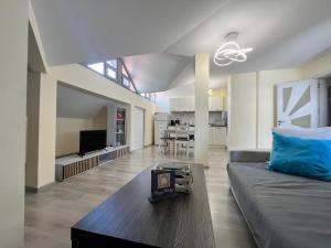 a living room with a couch and a table at Apartment Happy holiday Lazur in Burgas City