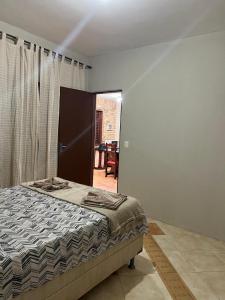 a bedroom with a bed in a room with a window at Casa de Praia - Praia Bela in Aquiraz