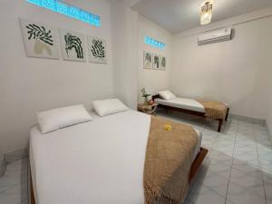 a bedroom with two beds in a room at Omah Padang Homestay Yogyakarta in Timuran