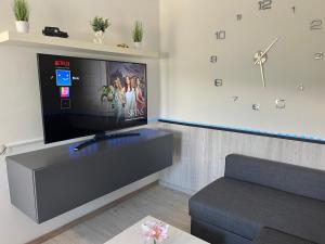 a living room with a flat screen tv and a couch at Apartment Romeo & Julija, Near terme Olimia, Free Parking, AC, Free Wifi in Podčetrtek