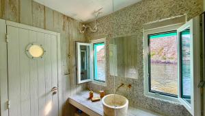 a bathroom with a sink and a window at Milos Boathouse-Between2seas Boutique in Areti