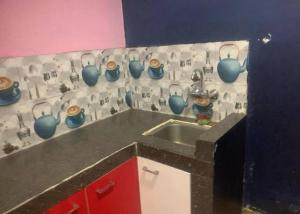 a kitchen with a sink and blue vases on the wall at Moktan Home Stay in Kathmandu