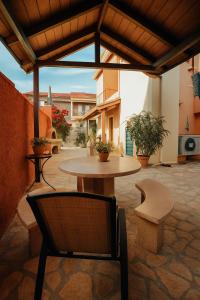 a patio with a table and a chair in a courtyard at villa Fotini 2 (new) in Syvota