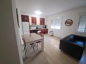 a kitchen and living room with a table and a couch at Apartamento calle Senado in Garrucha +5 photos