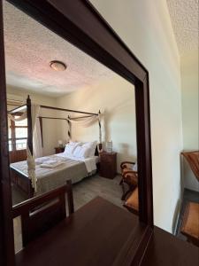 A bed or beds in a room at Akrotiri B&B