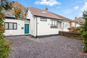 a white house with a blue door on a gravel driveway at OnSiteStays New Large modern 4 bed, Parking, Wifi, 2 x Bathroom in Orpington