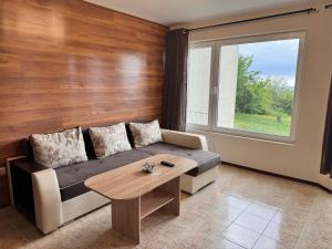 a living room with a couch and a table at Sea View 1 Bedroom Apartment - Pool & Free Parking - Kavarna in Kavarna