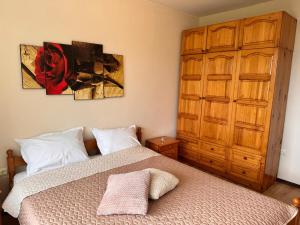a bedroom with a bed and a painting on the wall at Sea View 1 Bedroom Apartment - Pool & Free Parking - Kavarna in Kavarna +10 photos